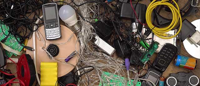 a table topped with electronics and wires.